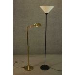 A contemporary brass floor standing reading lamp, with an adjustable arm and shade on a circular