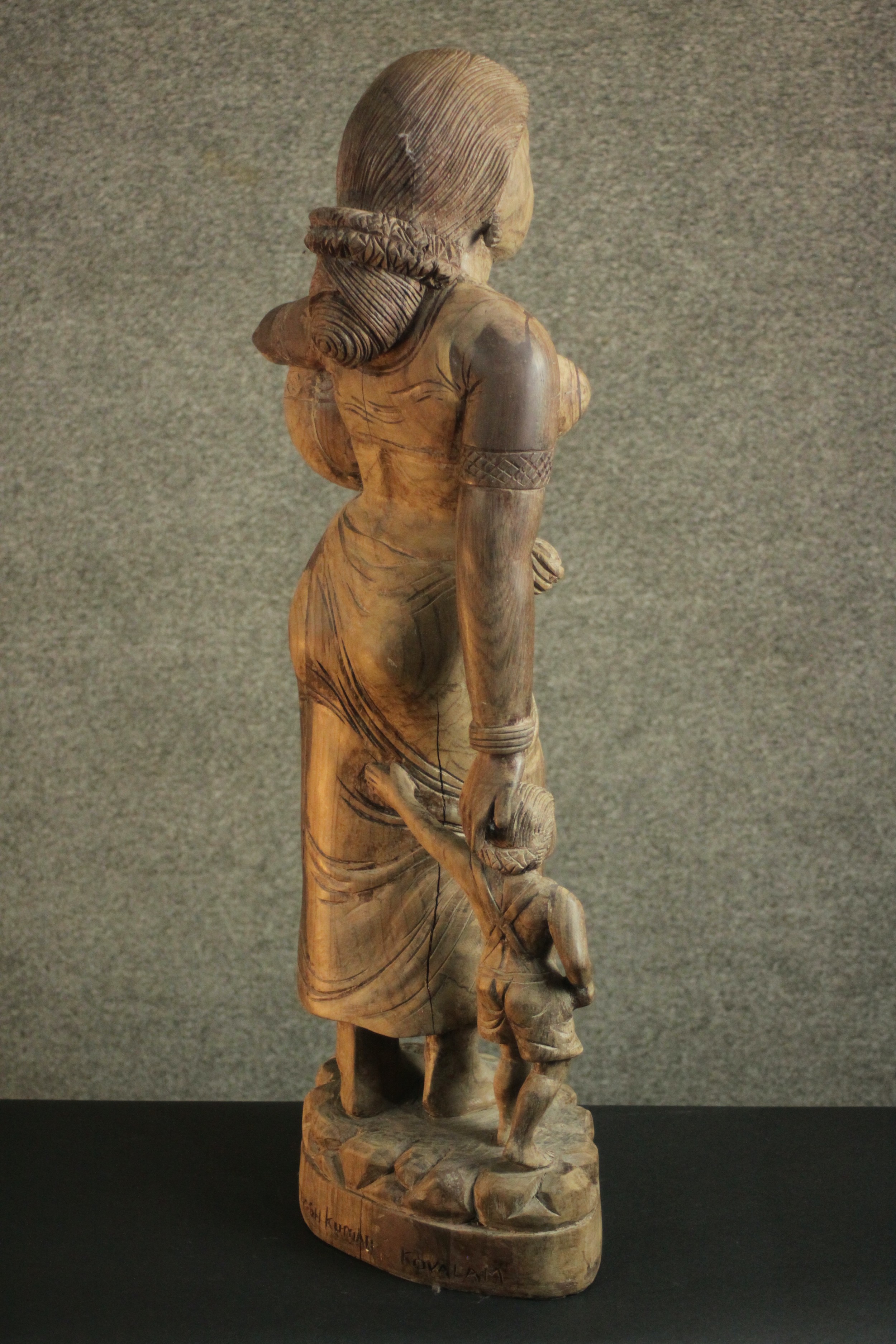 A 20th century carved figure of a woman holding her child's hand and carrying a water vessel. H.78 - Image 7 of 10
