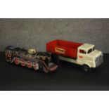 A vintage Tri-ang tipper truck and a similar tinplate locomotive. H.15 W.39 D.12cm. (largest)