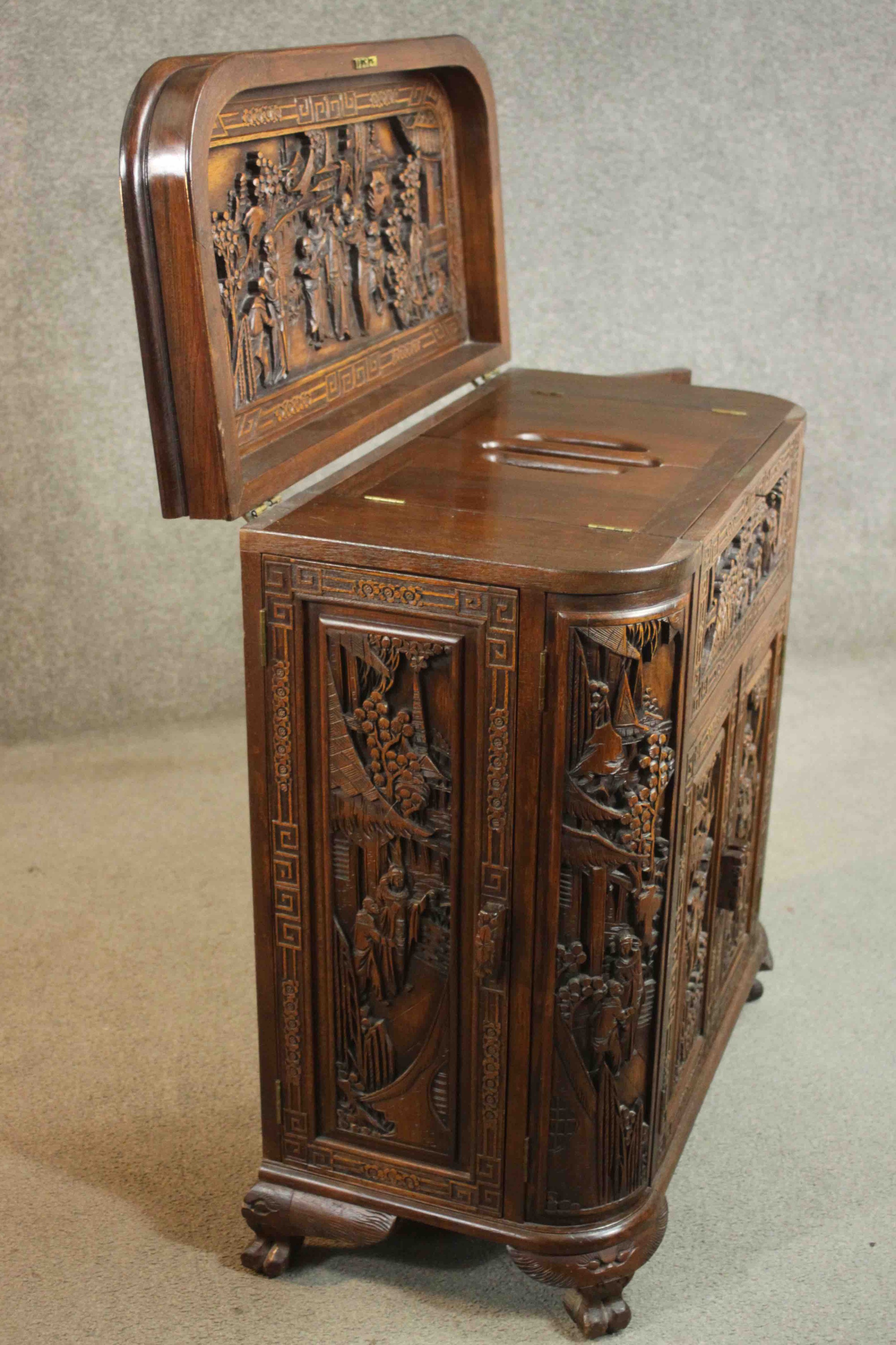 An early 20th century Chinese carved hardwood cabinet with central fitted drinks section. H.87 W. - Image 13 of 14