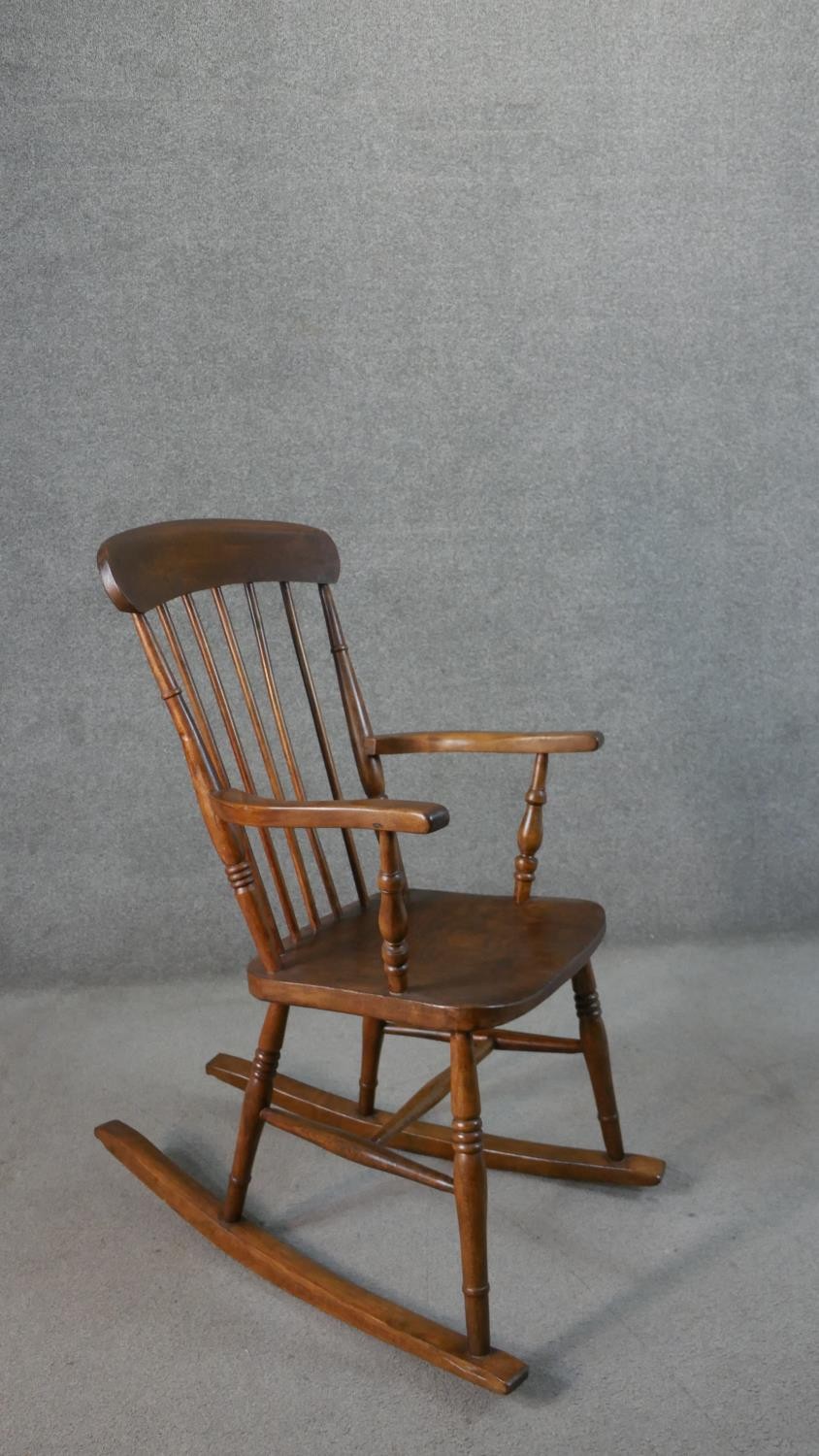 A 19th century style comb back rocking chair, with an elm seat, on turned legs joined by stretchers. - Image 2 of 4