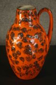 A large West German lava glaze pottery handled vase with brown splodged design, stamped West Germany