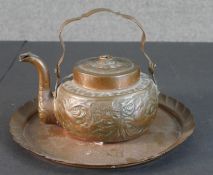 An Arts and Crafts repousse design copper tea pot with animals and foliate design along with a