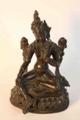 A 19th century bronze seated figure of Tara on a lotus form base. H.19 W.13 D.12cm.
