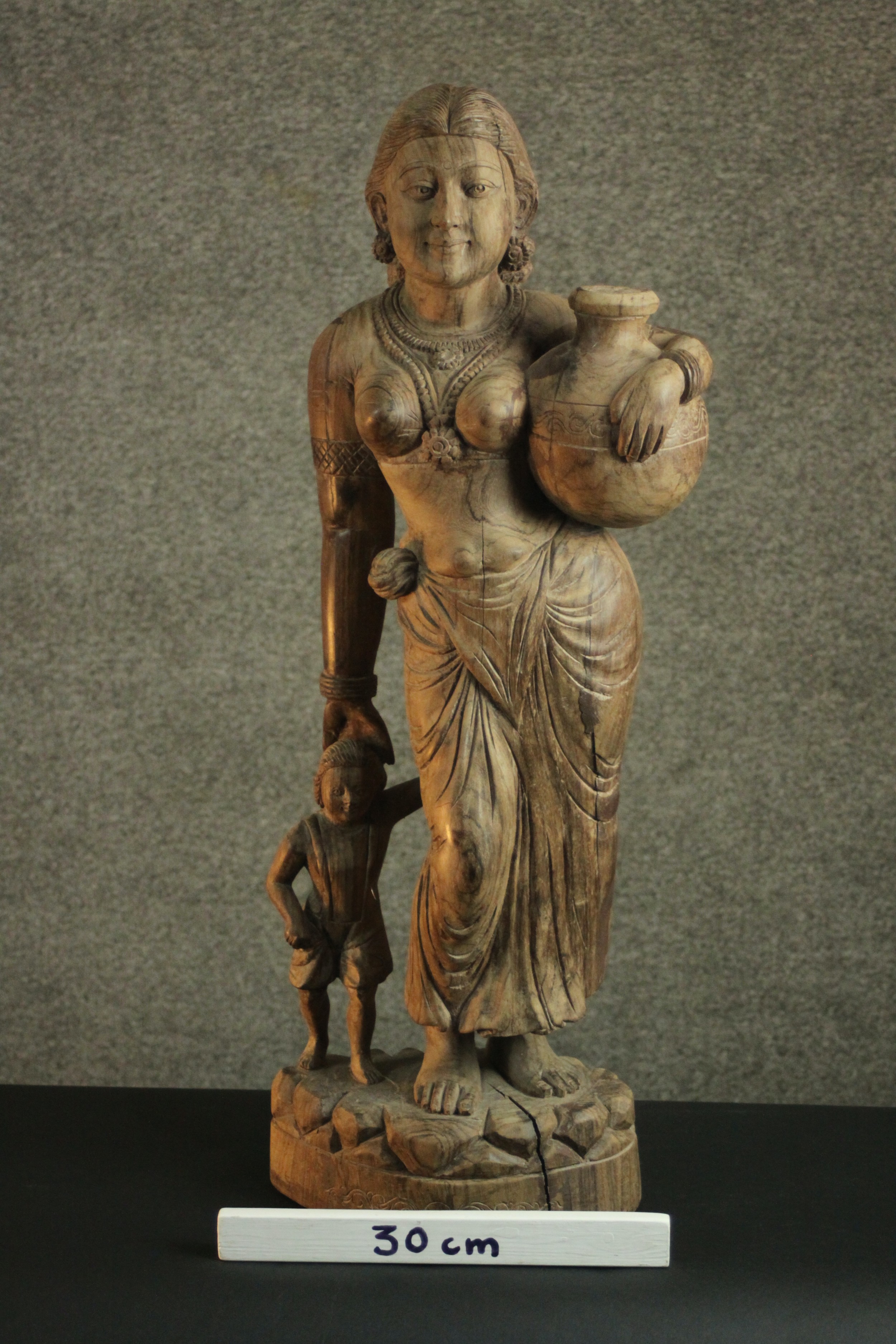 A 20th century carved figure of a woman holding her child's hand and carrying a water vessel. H.78 - Image 2 of 10