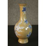 A Chinese early 20th century crackle glaze ceramic vase with painted blue and white prunus