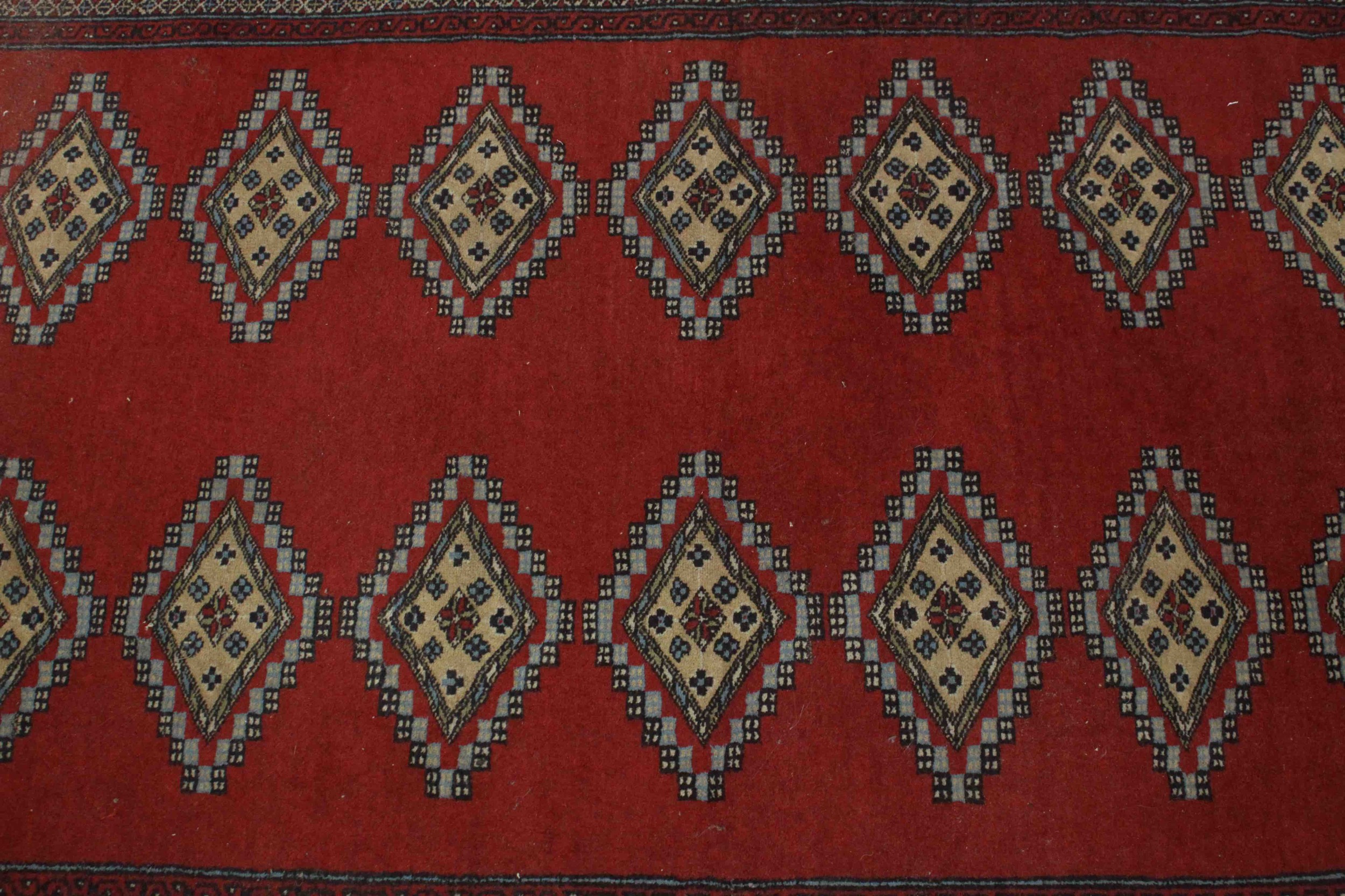 A Pakistan Bokhara with repeating diamond motifs on a burgundy field within stylised flowerhead - Image 4 of 6