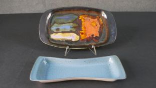 An Eric Leaper Newlyn studio pottery abstract design platter along with a Poole pottery blue glaze