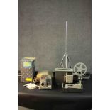 A vintage Super 8 projector and an Aldis 303 colour slide projector with screen. H.135 L.8cm.