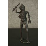 An African tribal bronze figure of a warrior throwing a spear. H.31 W.12cm