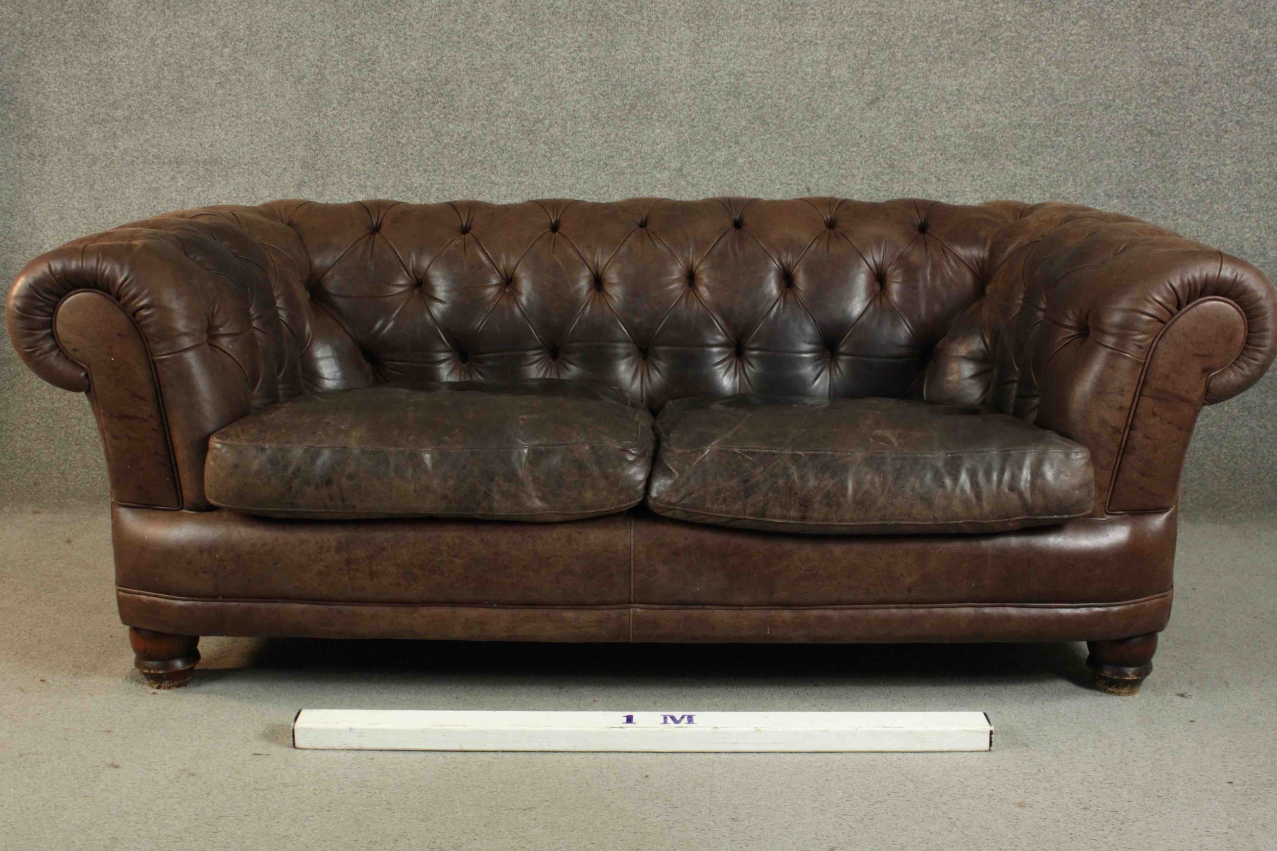 A contemporary brown leather Chesterfield sofa, with buttoned scrolling arms and back, on turned - Image 2 of 11