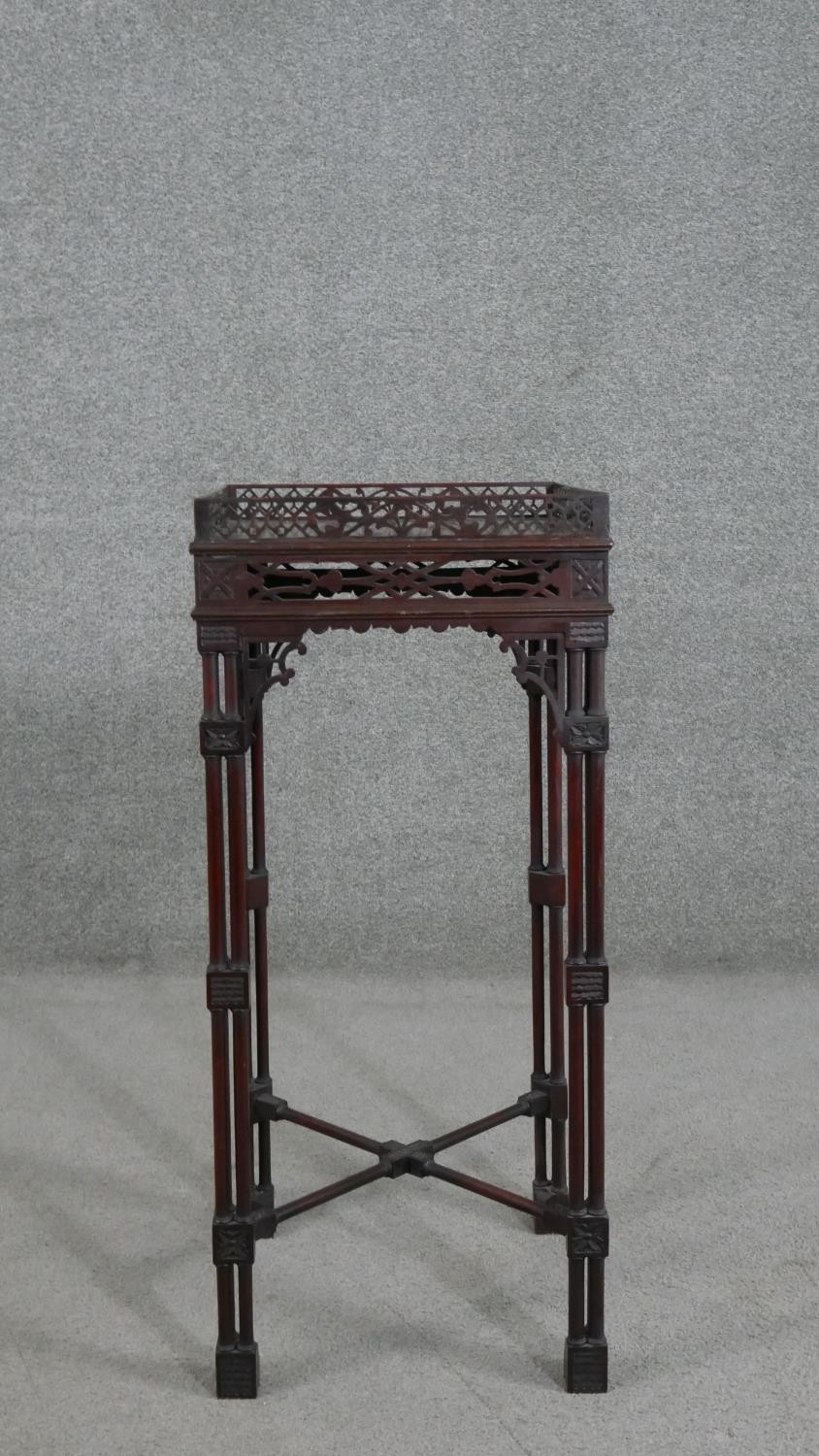 A late Victorian Chippendale style mahogany jardiniere stand, the square top with a pierced