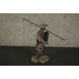 A 19th century Chinese painted metal figure of a rice farmer. H.22 W.12 D.30cm.