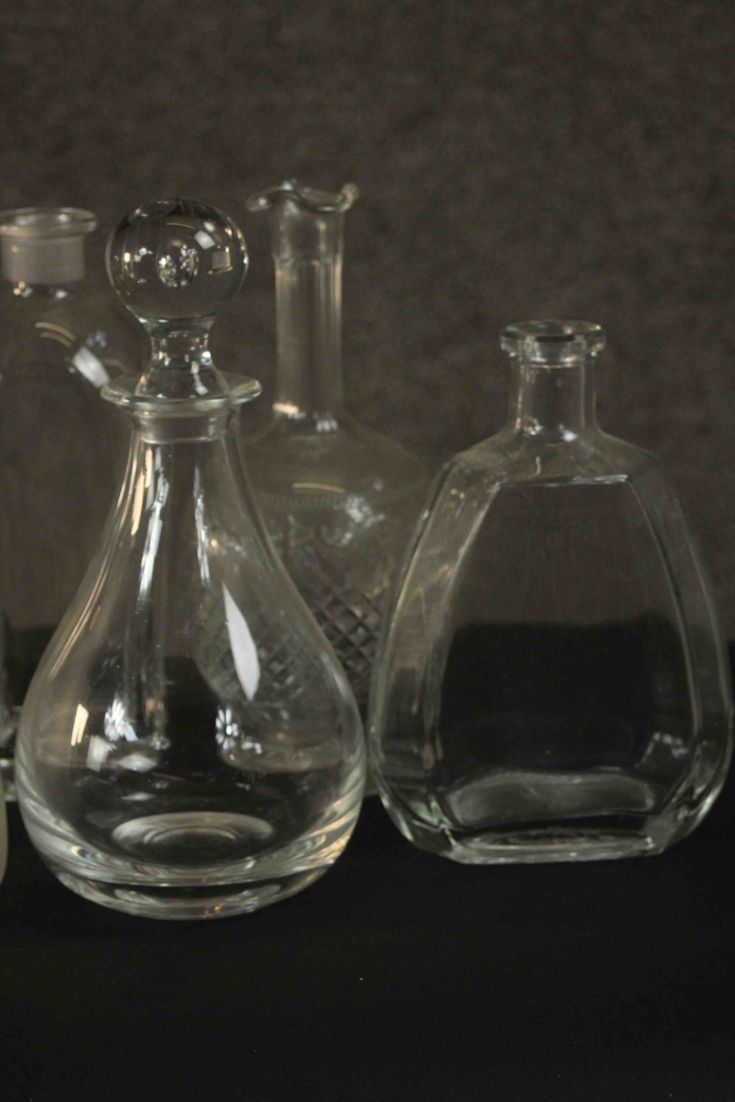 A collection of nine glass decanters, two clear crystal with blown glass stoppers. H.26 Dia.12cm. ( - Image 6 of 8