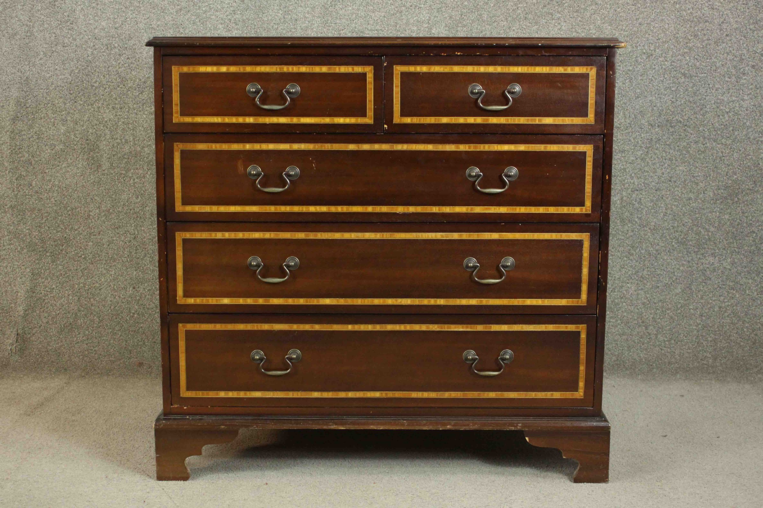 A 20th century Sheraton style mahogany and satinwood inlaid chest, the crossbanded top centred by an