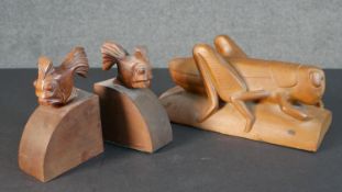 A large carved grasshopper along with a pair of burr walnut fish design bookends, indistinctly