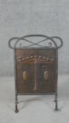 A Victorian Arts & Crafts planished copper fire screen, in a riveted wrought iron frame with