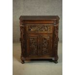 An early 20th century Chinese carved hardwood cabinet with central fitted drinks section. H.87 W.