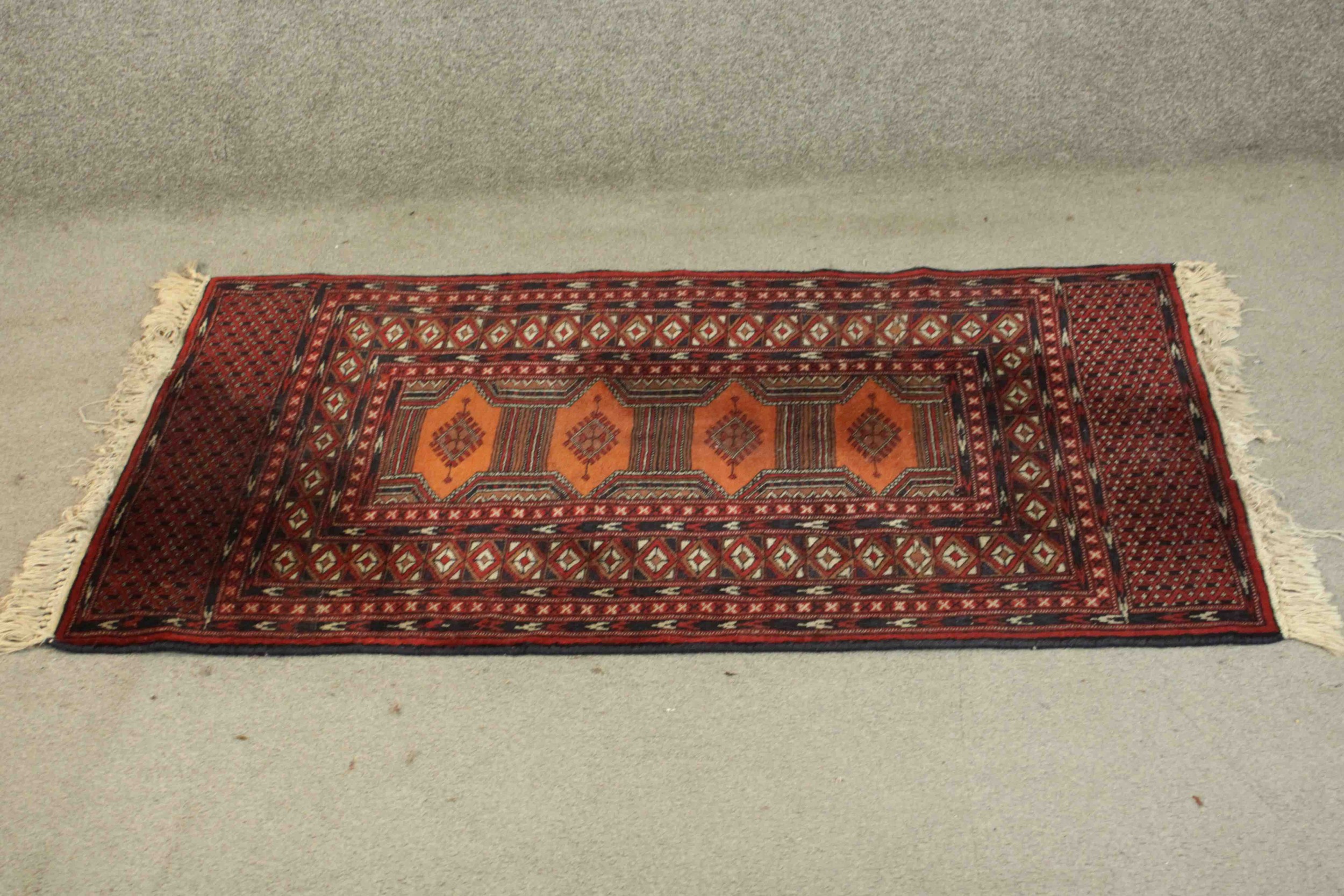 A Pakistan Bokhara rug with repeating pole medallions within multiple borders. L.126 W.80cm.