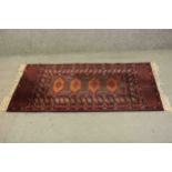 A Pakistan Bokhara rug with repeating pole medallions within multiple borders. L.126 W.80cm.