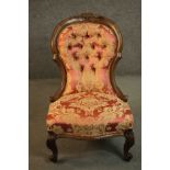 A late 19th century walnut spoon back chair, upholstered in red and gold fabric with a button