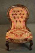 A late 19th century walnut spoon back chair, upholstered in red and gold fabric with a button
