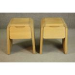 A pair of contemporary oak bedside tables, of inverted U shape with a single drawer and a recessed