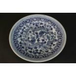 A large Chinese blue and white hand painted dragon design ceramic plate. Bamboo leaves to the