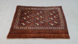 A hand made ochre ground Persian Turkmen rug. L.113 W.78cm