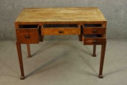 A walnut and crossbanded Art Deco kneehole writing table on tapering shaped supports. H.74 W.100 D.