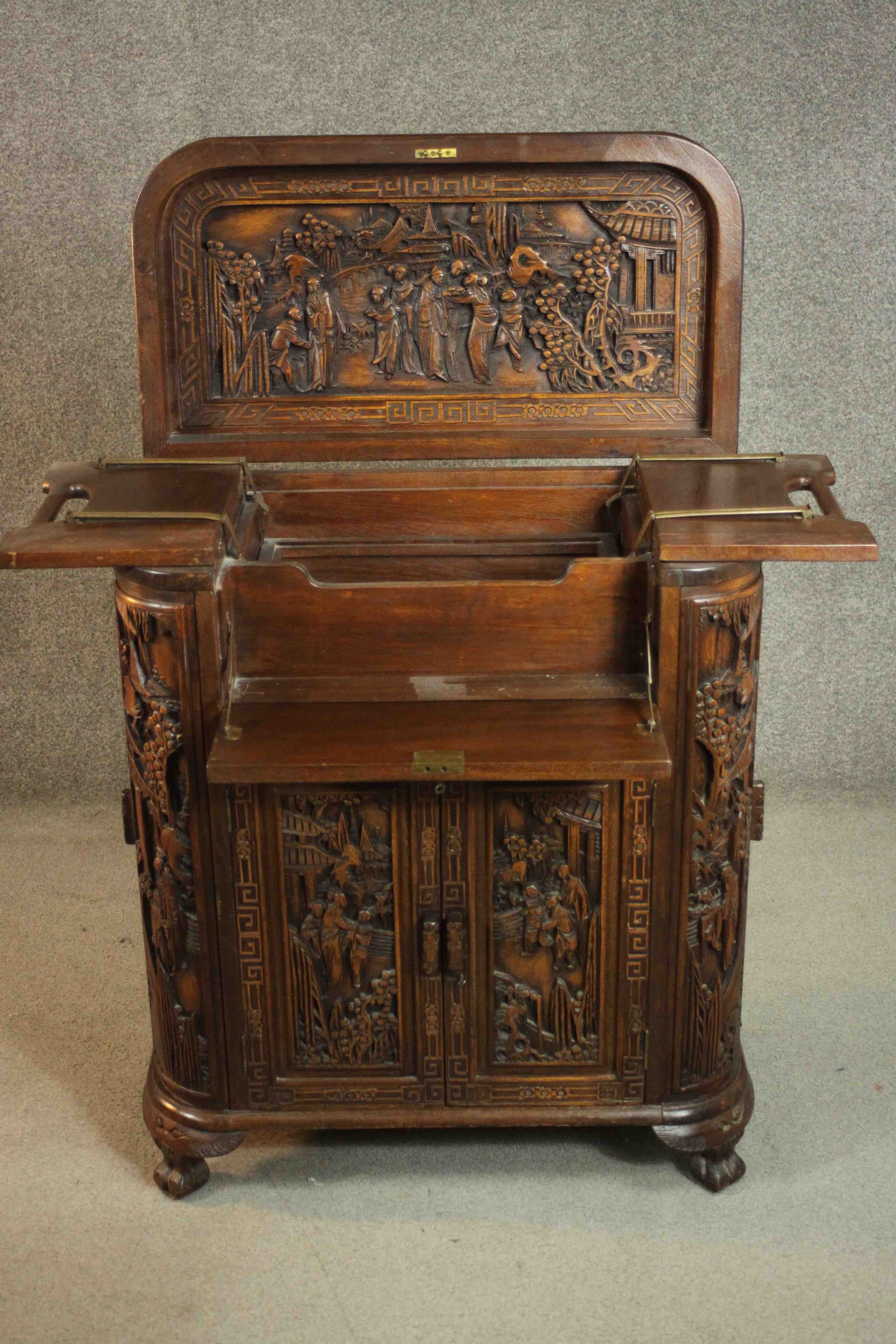 An early 20th century Chinese carved hardwood cabinet with central fitted drinks section. H.87 W. - Image 5 of 14