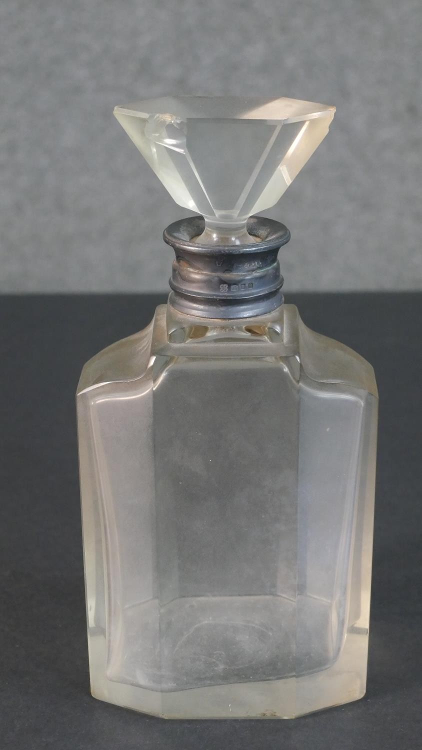 An Art Deco silver collared crystal decanter with fan shaped stopper. (chipped) Hallmarked: WB&S for