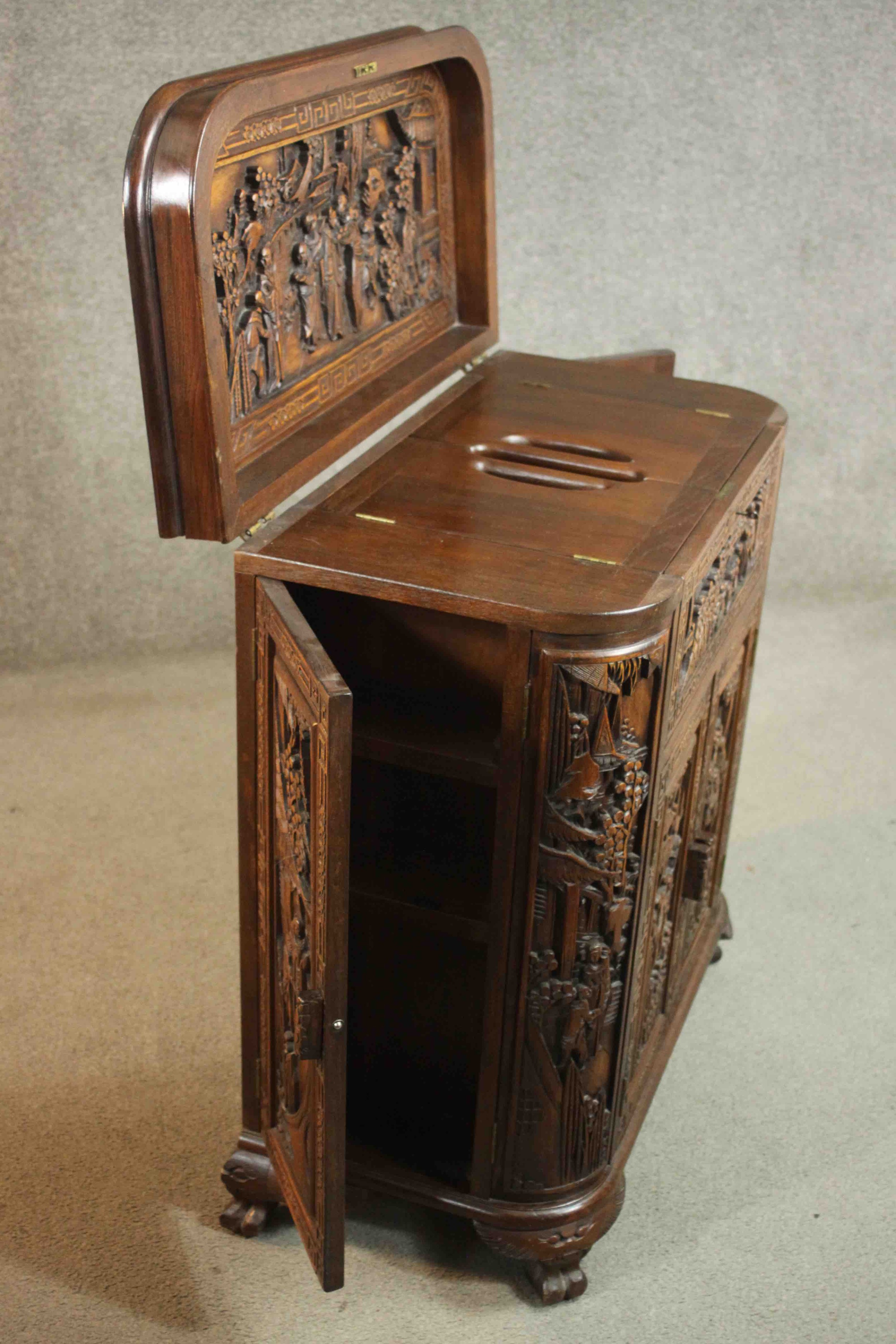 An early 20th century Chinese carved hardwood cabinet with central fitted drinks section. H.87 W. - Image 12 of 14