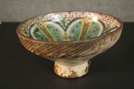 A 19th century Persian hand painted geometric design ceramic footed bowl. H.14 Dia.27cm.