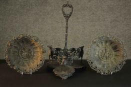 Two Victorian cast iron relief classical design plates along with a pewter three bottle tantalus