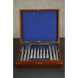 A mahogany canteen of silver plated cutlery for six people. The blades engraved with a floral design