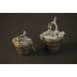Two sets of 19th century bronze apothecary weights in the form of buckets with hinged lids and