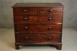 A Victorian mahogany chest of two short over three long graduated cockbeaded drawers with turned