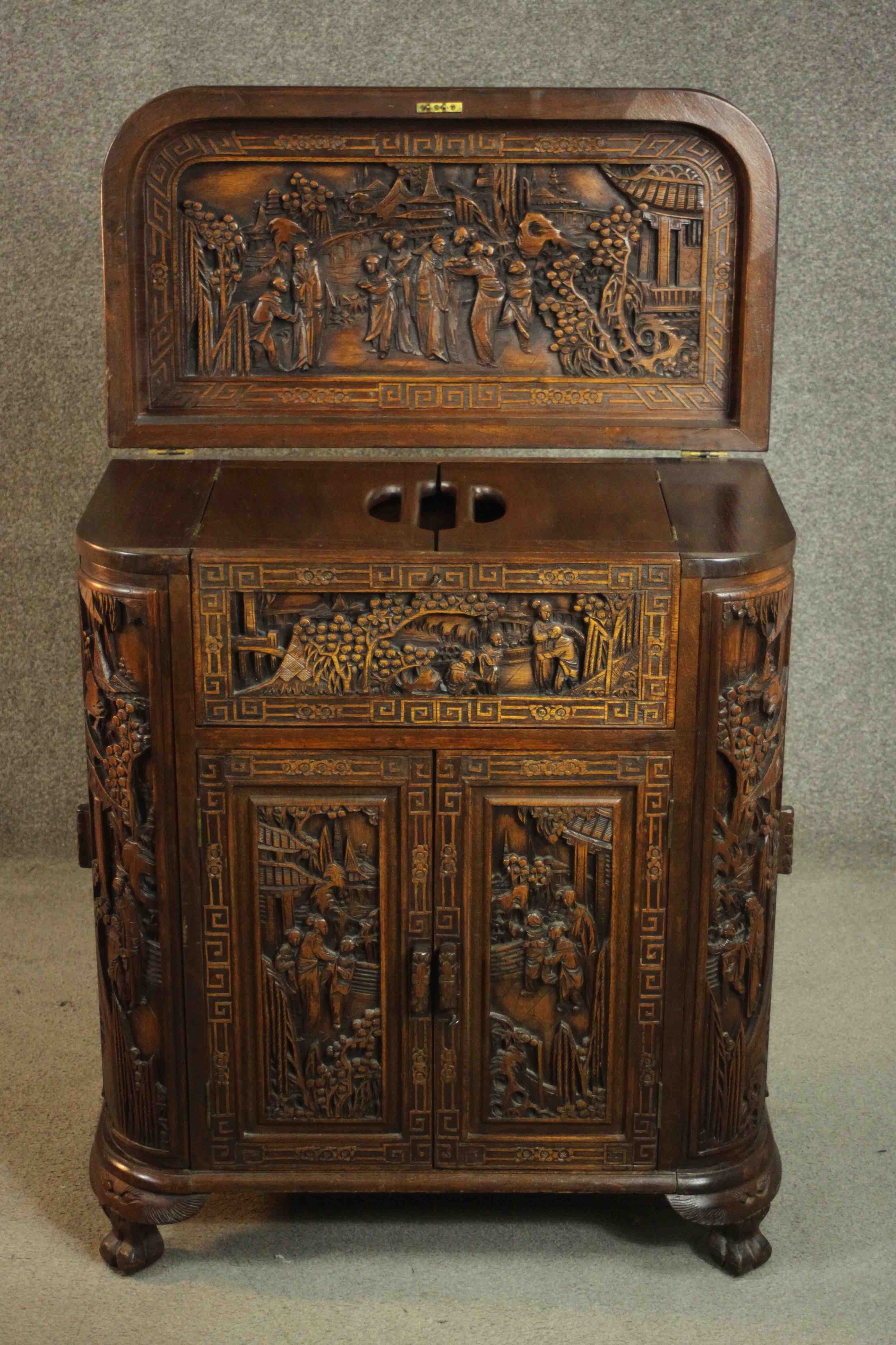 An early 20th century Chinese carved hardwood cabinet with central fitted drinks section. H.87 W. - Image 4 of 14