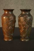 A pair of Meji period Japanese relief bronze and mixed metal vases. Each one decorated with storks