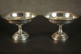 A leather cased set of two weighted sterling silver pedestal tasting cups. Hallmarked: MMH for M M