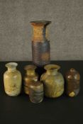 A collection of six brown and green marbled glaze stoneware pots. Impressed M mark to the base of