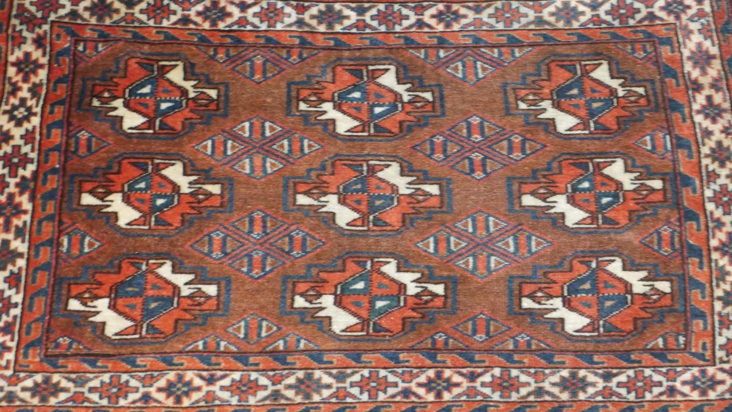 A hand made ochre ground Persian Turkmen rug. L.113 W.78cm - Image 2 of 4