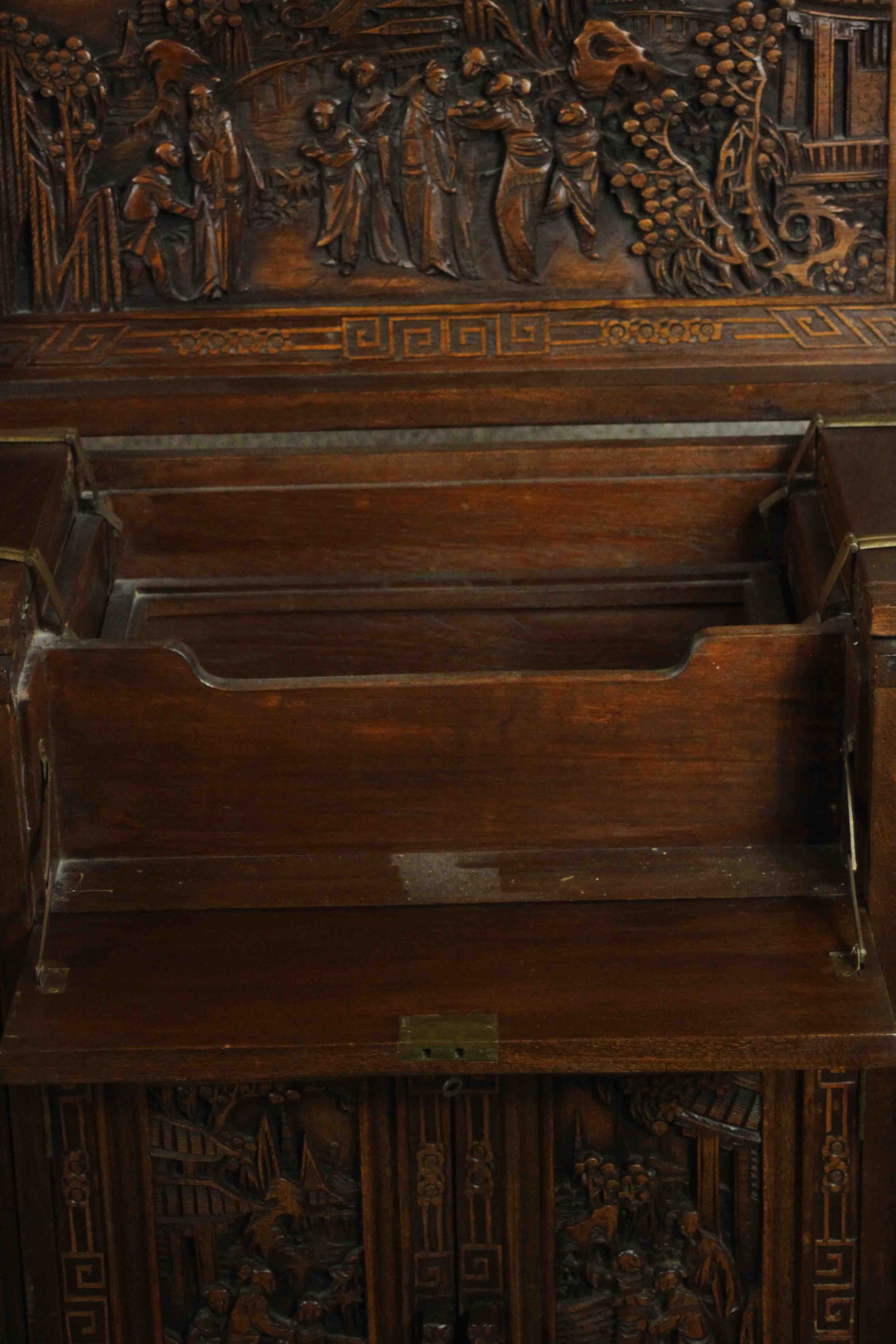 An early 20th century Chinese carved hardwood cabinet with central fitted drinks section. H.87 W. - Image 7 of 14