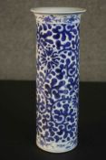 A Chinese 19th century blue and white cylindrical vase with hand painted stylised floral and foliate