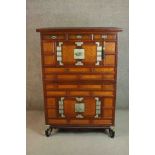 A Korean hardwood bandaji cabinet, with three short drawers over a pair of cupboard doors, above