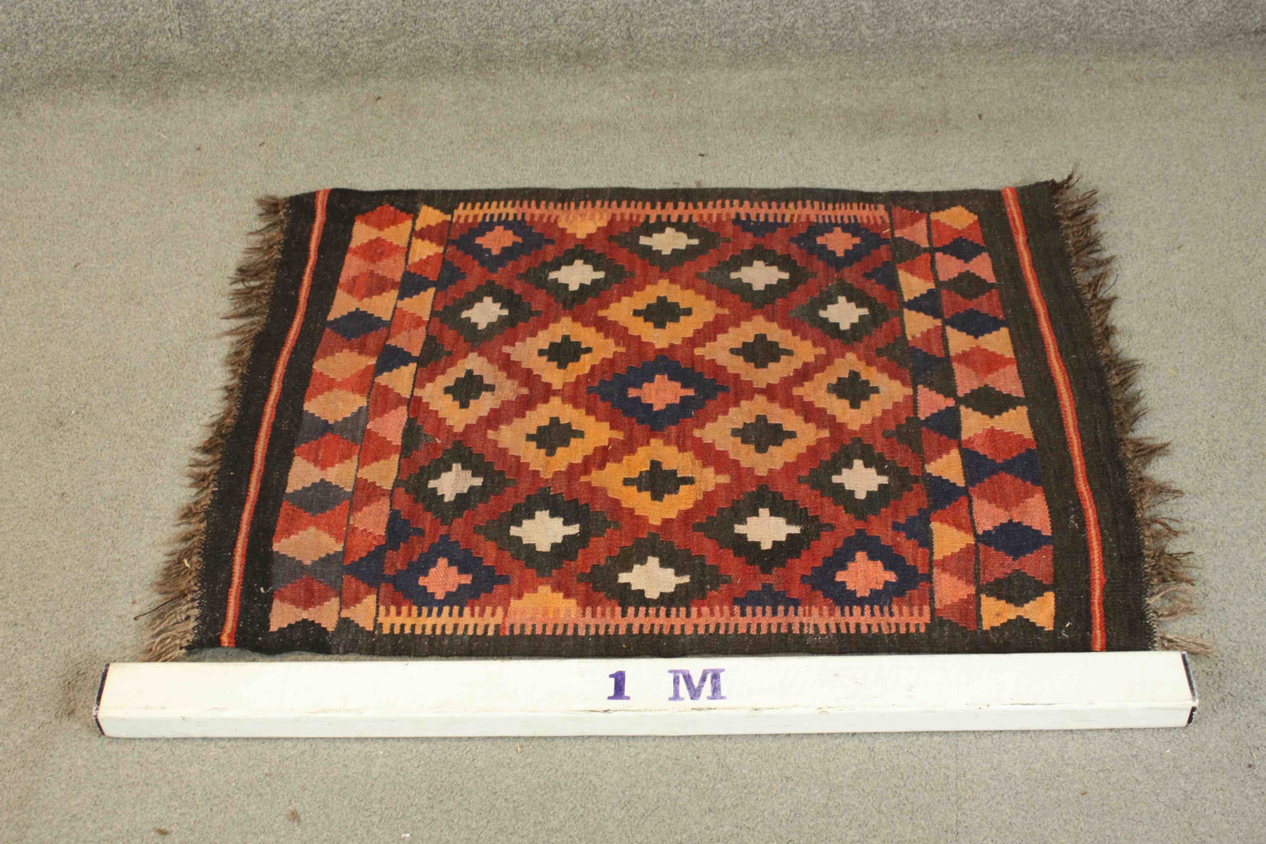 An Afghan Kelim rug with repeating diamond motif on a terracotta ground. L.94 W.69cm. - Image 2 of 5