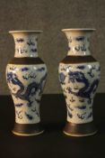 A pair of Chinese early 20th century crackle glaze blue and white dragon design vases. Character