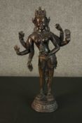 A large 19th century Indian bronze figure of a many armed deity on a lotus form base. H.45 W.25 D.