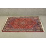 A Persian Bidjar rug the central medallion with stylised floral design within spandrels and multiple